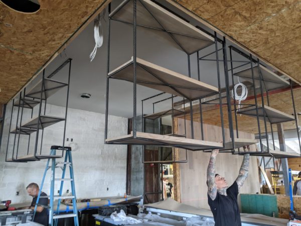 Hanging shelves made from rebar with walnut shelves